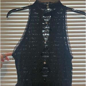 Black lace free people mini dress with button detailing on the back.